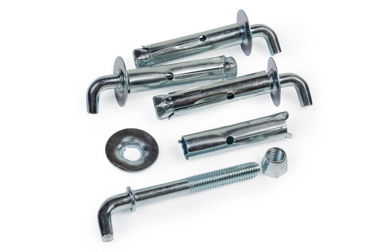 Several metal components, including wall anchors, hooks, and fasteners against a plain white background.